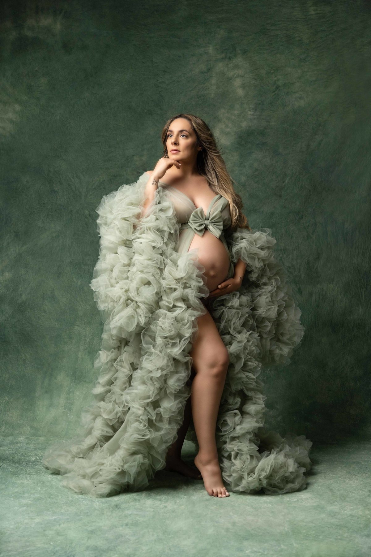 Expectant mother in a sage tulle gown at a maternity photography session near Pickering, Ontario