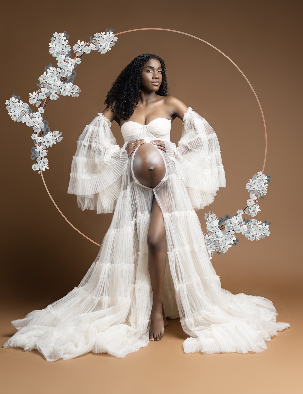 Styled maternity photography in a white gown with a floral hoop, Durham Region