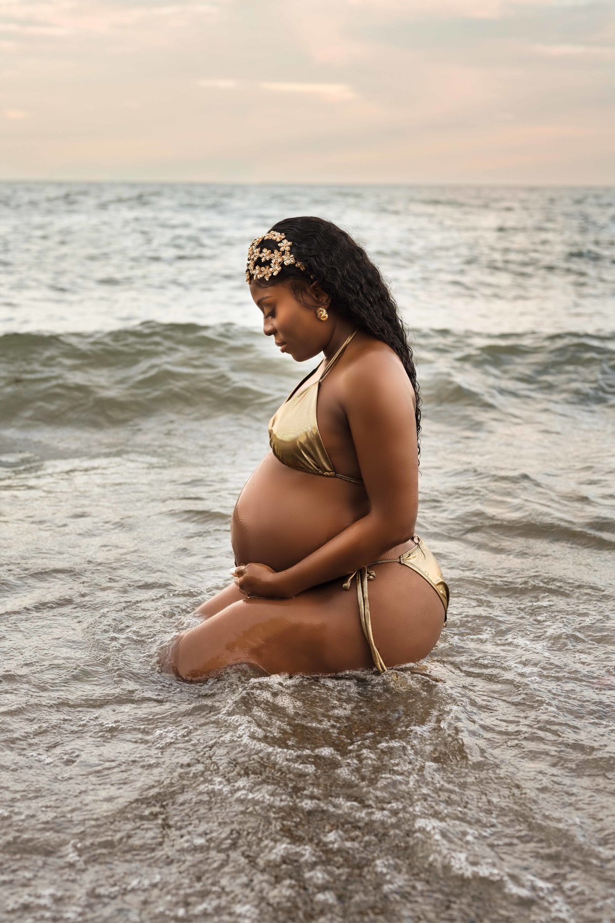 Maternity photography in soft natural light by the water