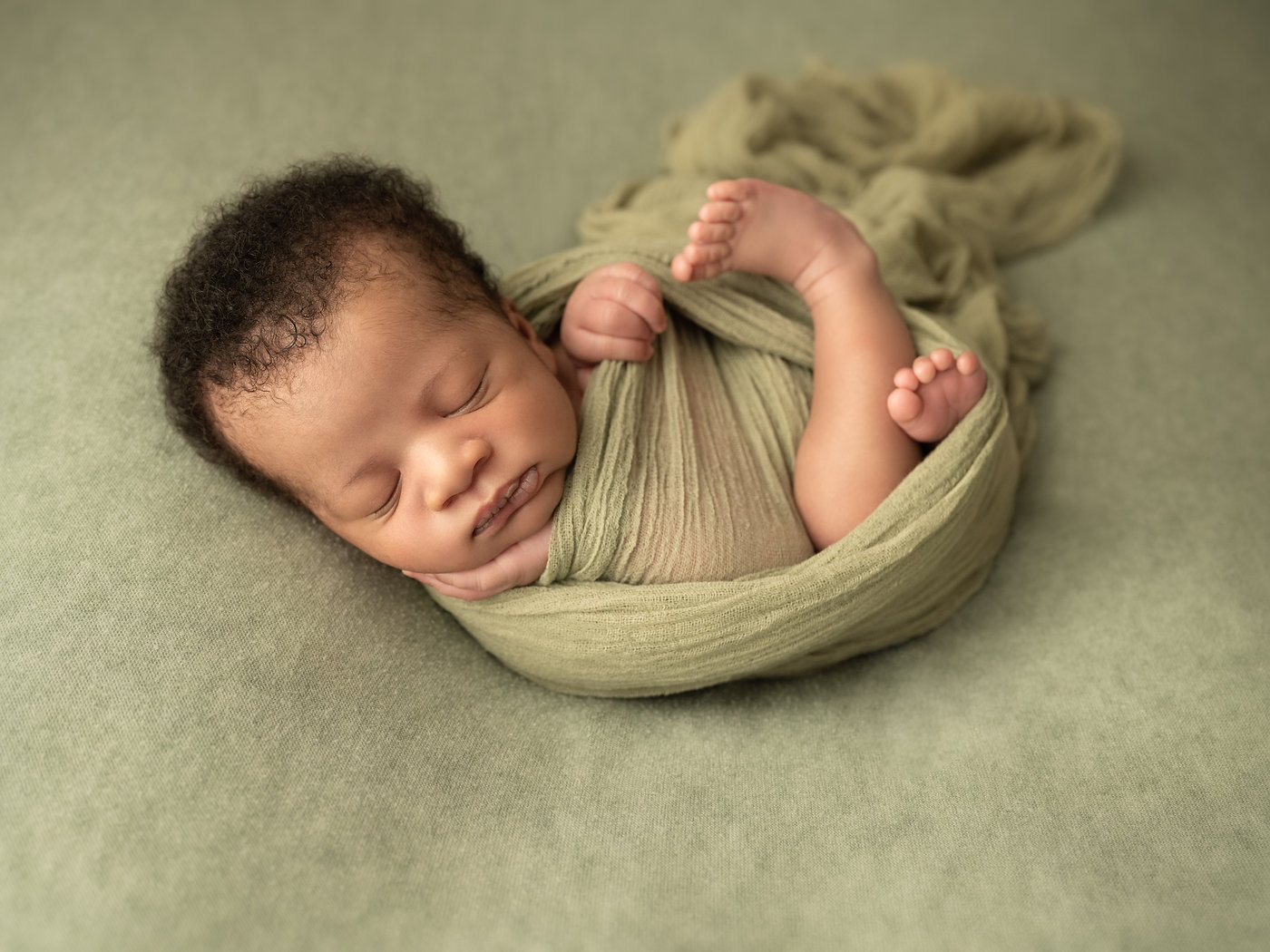 Styled newborn photography with wraps and props